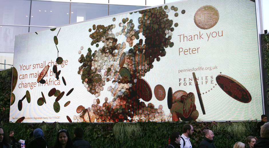 A pennies for life digital billboard which encouraged passers-by to donate to the MicroLoan foundation. For every donation, the person who donated was thanked with a sequence of dropping pennies which formed a smiling woman.
